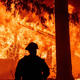 Firefighters attempt to get control of the scene as dozens of homes burn during the Dixie in the Indian Falls neighborhood of unincorporated Plumas County, California on July 24, 2021.